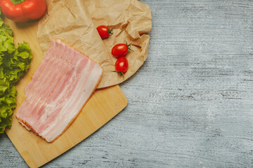 Sliced pork ham with vegetables and free space for the recipe. Template for home cooking, fast lunch recipe