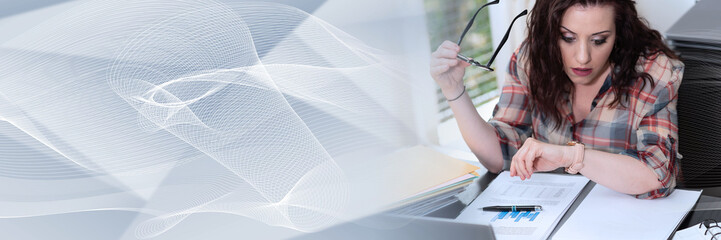 Stressed businesswoman looking at her watch; panoramic banner