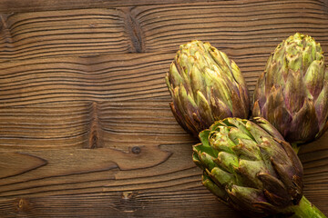 Fototapeta premium Green and purple artichoke flower buds pattern, top view