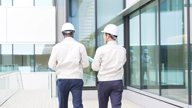 Group of multinational engineers walking through a building