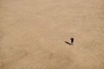 Person searching phone network at the Beach