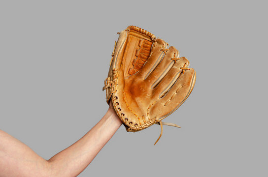 Hand of baseball player with glove isolated on gray. Baseball, active leisure, sports, championship. - Powered by Adobe