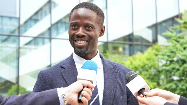 Black man speaking at a press conference