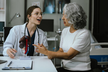 Female doctor consulting senior old patient filling form at consultation, talking to senior old patient filling signing medical paper at appointment visit in clinic.