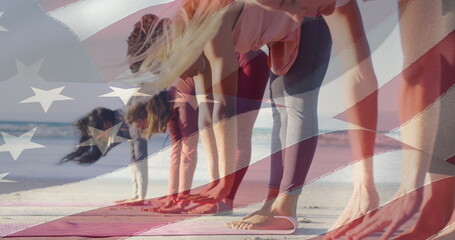 Image of american flag over diverse women exercising at beach