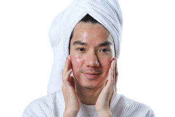 Smiling man taking care of skin for rapid recovery after laser resurfacing, applying moisturizer on...