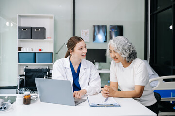 Portrait of female doctor explaining diagnosis to her patient. Doctor Meeting With Patient In Exam...