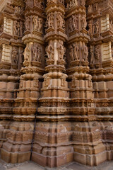 Ancient sculpture and intricate designs on the pillar of Chitragupta Temple in the Khajuraho temple complex, India