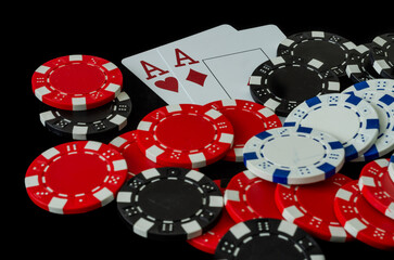 Poker chips and cards in a casino on a black background