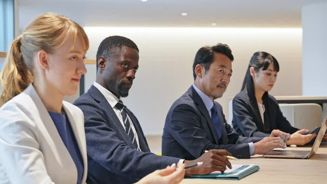 Group of multinational business people meeting in a conference room