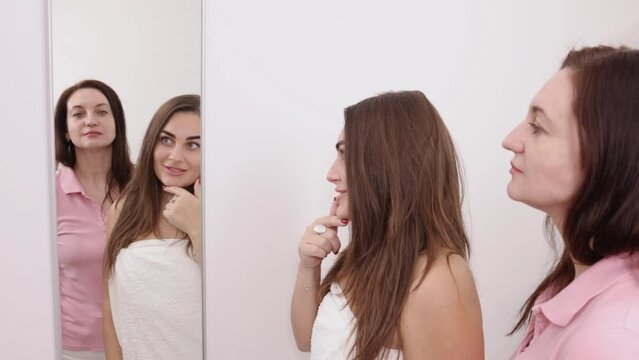 Skin concerns, Personalized care, Beauty consultation. The female client uses a mirror to display the areas of her face that require attention to the beautician.