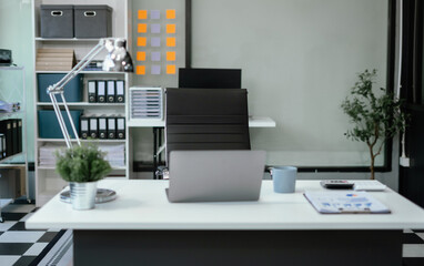 workspace area with laptop tablet smartphone and paperwork on the table in the office concept.