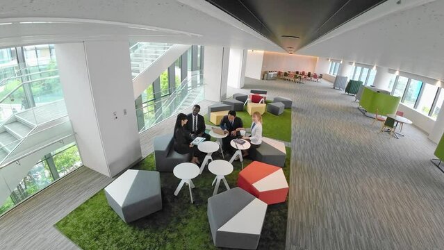 Aerial view of people in a meeting in the lobby from a surveillance camera