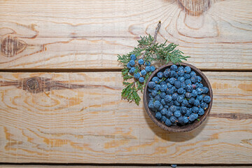 Juniper tree seeds on a wooden floor.