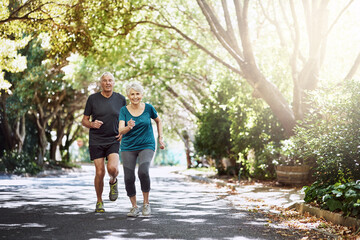 Running, outdoor and old couple with fitness, sunshine and bonding together with challenge. Park, senior man and woman with training, retirement and hobby with wellness, exercise and healthy