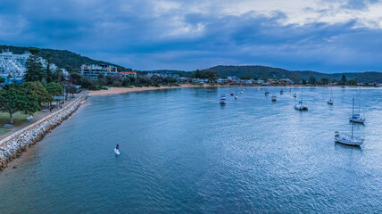 Aerial sunrise waterscape with boats and a mix of high cloud and rain clouds