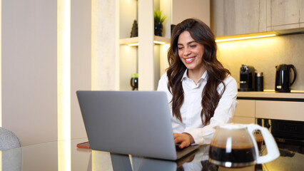 Beautiful, young businesswoman working online from home