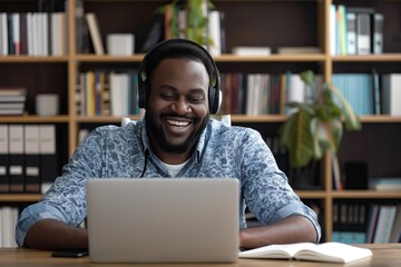 Cheerful Man Wearing Headphones Using Laptop