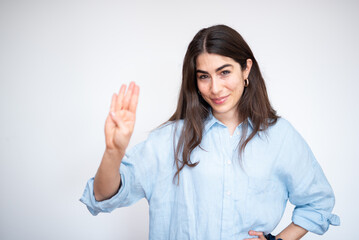 Businesswoman smiling and raising four  fingers on white background