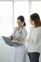 Female doctors who treat patients make an appointment to listen to the results after a physical examination and explain medical information and diagnose the disease. Medical concepts and good health