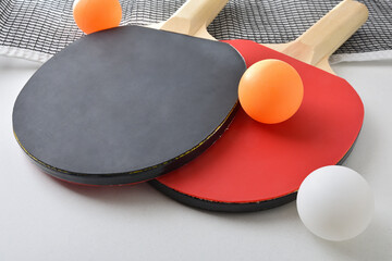 Background with set of table tennis paddles net and balls