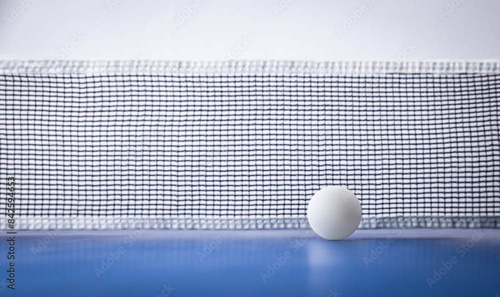 Wall mural Ping-pong background with ball on blue table front view