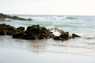 Waves hitting the beach and Rocks on the coast © Louis