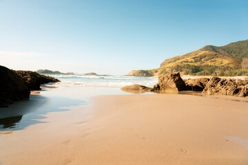 Waves hitting the beach and Rocks on the coast