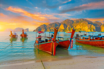 Longtail boats at the beautiful beach Thailand early morning at dawn beautiful sky clouds over...