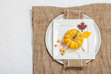 Autumn table setting. Thanksgiving cutlery, traditional fall decor. Cozy mood, minimalist design