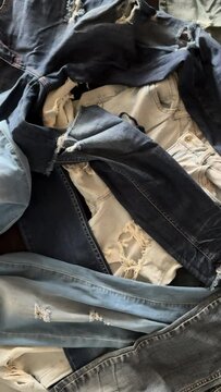 large pile of old jeans concept for fashion industry, reducing waste, recycle material