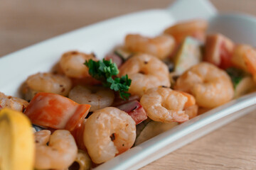 Shrimp salad with lemon on a white plate