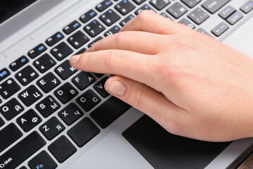 Female hands typing on modern laptop, closeup
