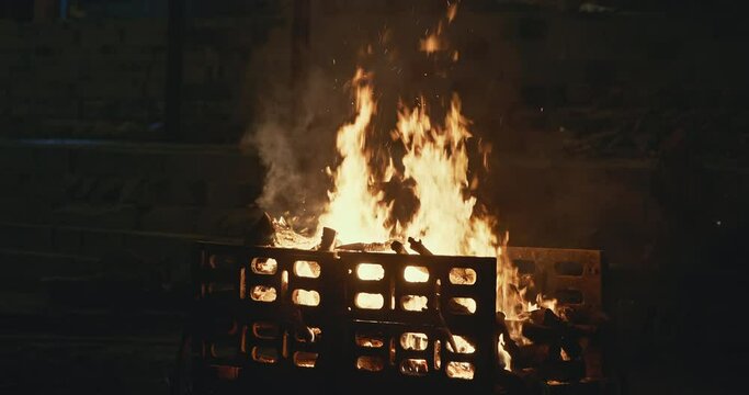 Varanasi, Uttar Pradesh, India. Cremation on Manikarnika Ghat. night lights. Fire, smoke - Funeral rites of cremation close up