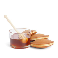 Tasty pancakes and glass of honey on white background