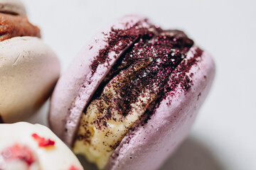 macro photo of macaroons on a while background.Chocolate french macaroon cookies isolated on white background..
