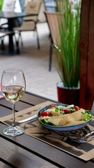 A festive table in a restaurant on a summer terrace with alcoholic drinks and meat and pork food