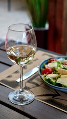 A festive table in a restaurant on a summer terrace with alcoholic drinks and meat and pork food