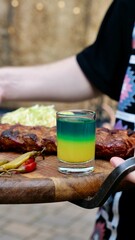A festive table in a restaurant on a summer terrace with alcoholic drinks and meat and pork food
