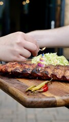 Food in a restaurant with meat pork, steak, sausages, tartar on a table with drinks on a summer terrace