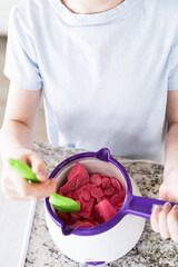 Crafting Sweet Treats: Young Chef Prepares Chocolate-Dipped Pretzels