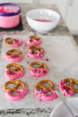 Homemade Gourmet: Delightful Pretzels Adorned with Pink Chocolate and Sprinkles