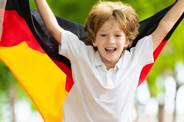 Child running with Germany flag.
