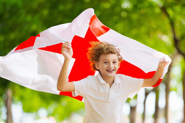 Child running with England flag. English supporter