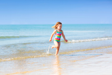 Kids playing on beach. Children play at sea.