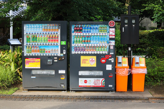 TOKYO, JAPAN - June 6, 2024: A pair of drinks vending machines in Tokyo's Ueno Park. A notice on them states that in the event of a disaster, drinks from the machine will be available for free.