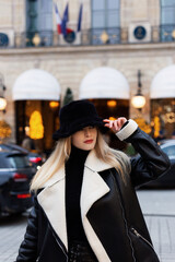 Obraz premium Beautiful woman on the street. Happy lifestyle and holiday concept. Woman in a black hat panama