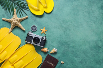 Beautiful composition with starfishes, beach accessories and photo camera on green grunge background