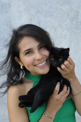 Obraz premium Pretty woman with a very cute black baby cat 