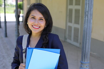 Nice female student smiling outdoors 